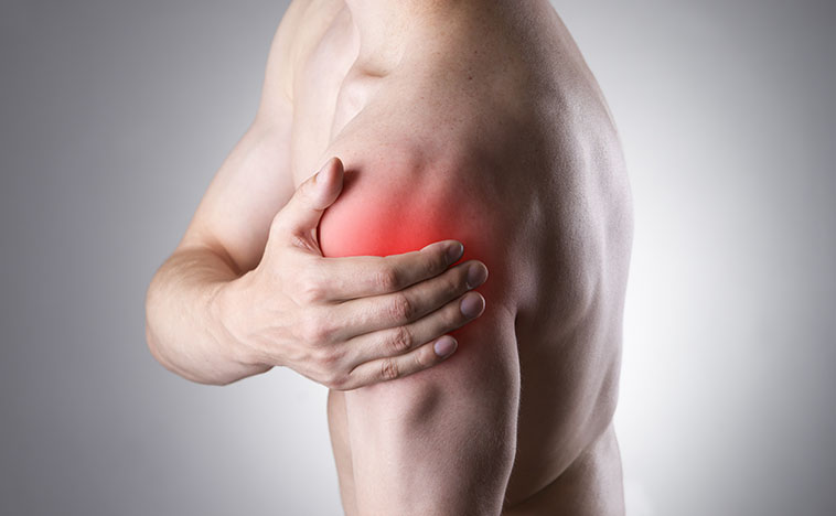 Man with pain in shoulder. Pain in the human body on a gray background with red dot