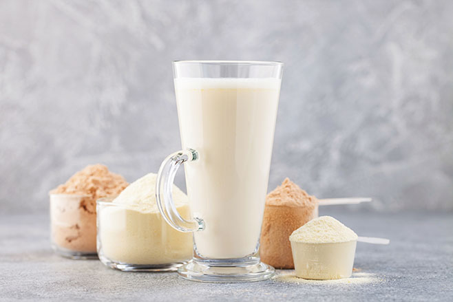 Sports nutrition, fitness diet and food concept - protein shake powder on grey background