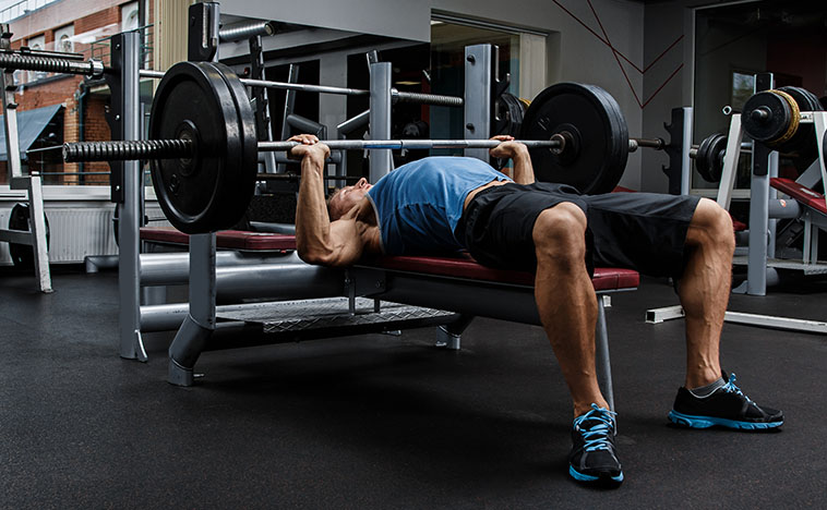 Man during bench press exercise in gym